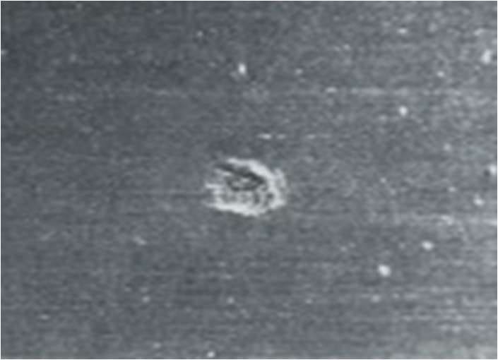 Close-up photograph of an impression type roll mark on a cold rolled steel strip surface