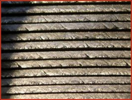 Cold rolled coil wall showing early stage serrated edge with 45 degree slip lines