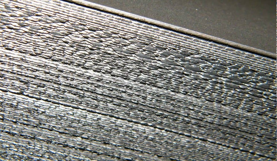 Cold rolled coil side wall showing fully developed serrated edge with separated cracks