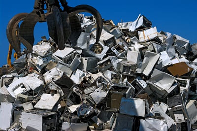 White goods appliance scrap showing abundant post-consumer steel feedstock available in G7 economies for electric arc furnace production