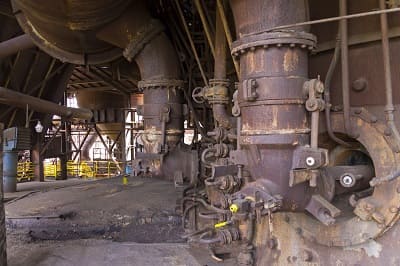 Mothballed steel works showing idle blast furnaces representing overcapacity crisis
