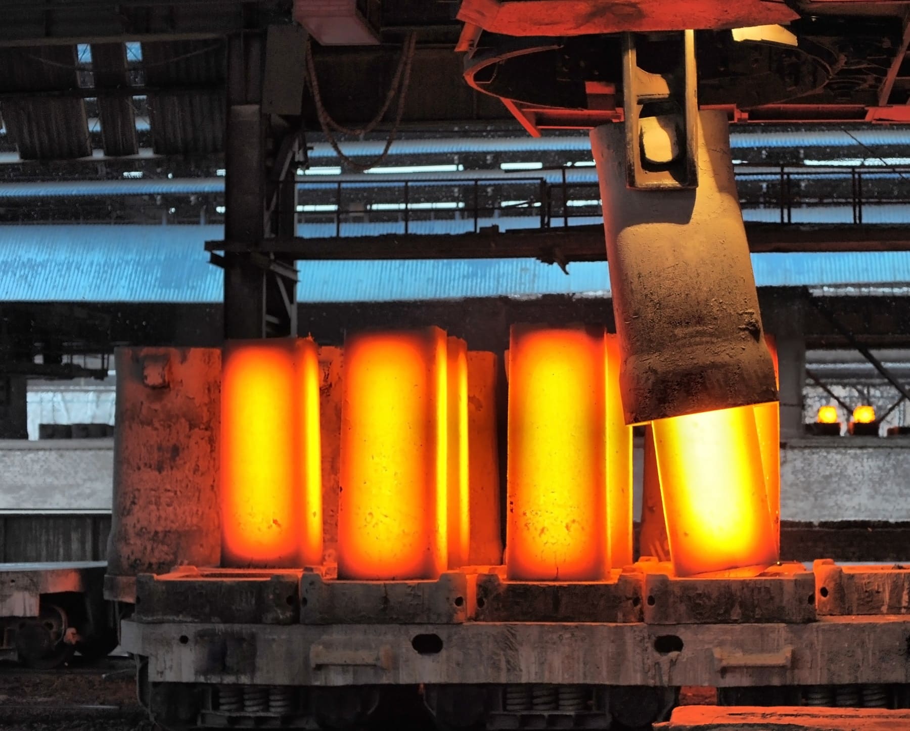 Red-hot pig iron billets in reheat furnace