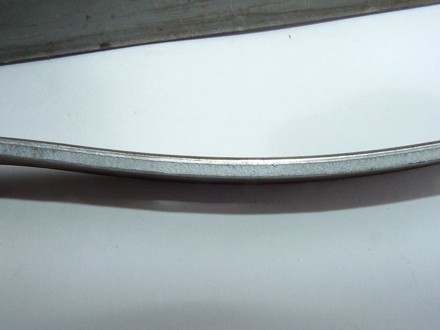 Close-up photo of a correctly trimmed strip edge showing shiny nick zone and darker break zone