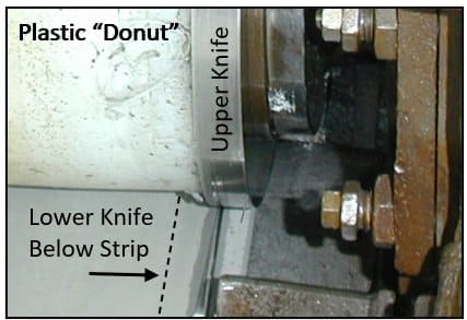 Side trimmer equipment showing plastic donut positioned against the upper knife