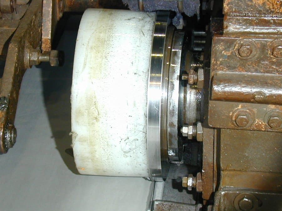 Close-up of side trimmer hold-down donut mounted against the upper knife blade