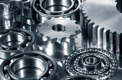 Precision gears and bearings manufactured from specialty steel grades