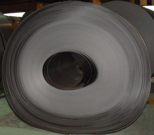 Steel coil showing soft collapse failure — the coil has deformed from a circular to an oval shape under its own weight