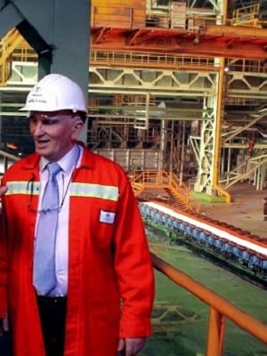 Industrial consultant inspecting continuous casting operations for multilateral development bank