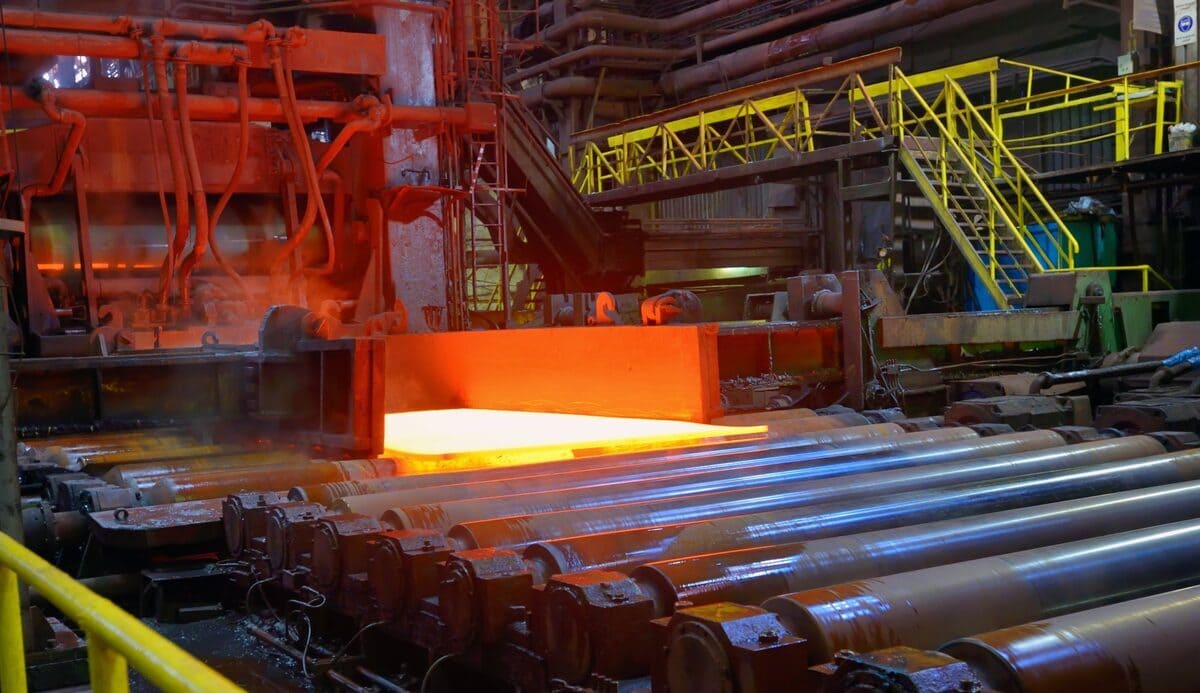 Modern steel rolling mill production facility showing hot steel processing